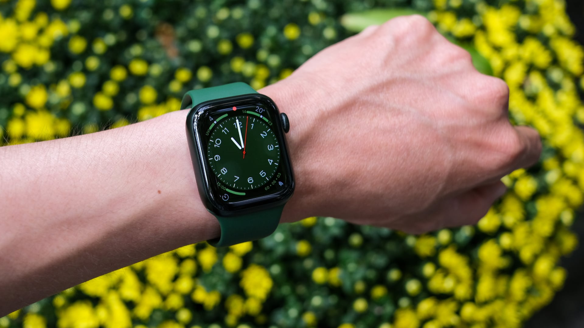 Green Apple Watch Series 7 worn on a male wrist